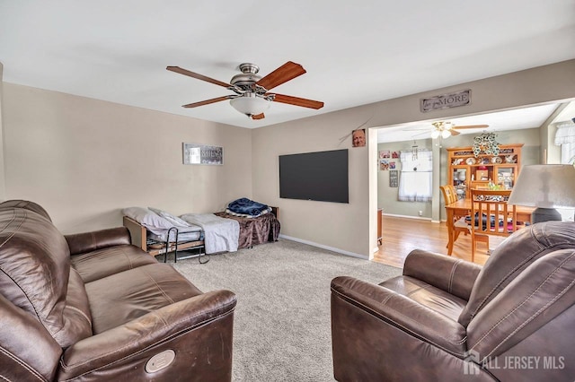 living room with light carpet and ceiling fan