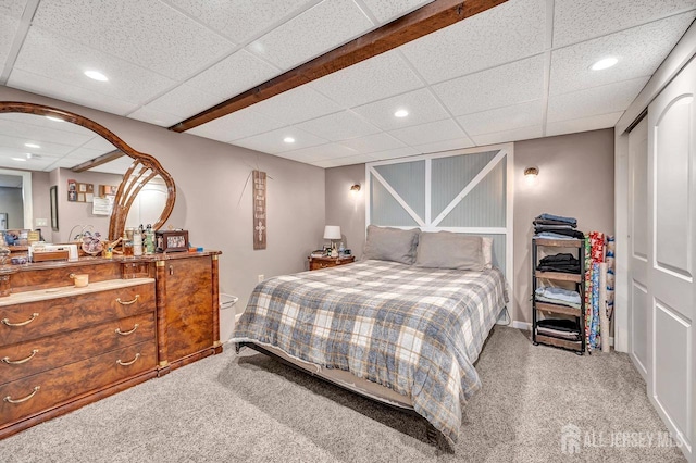 bedroom featuring carpet floors and a drop ceiling