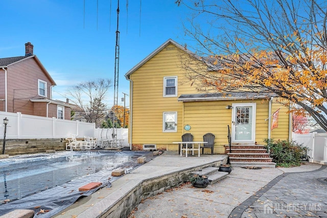 rear view of property featuring a patio area