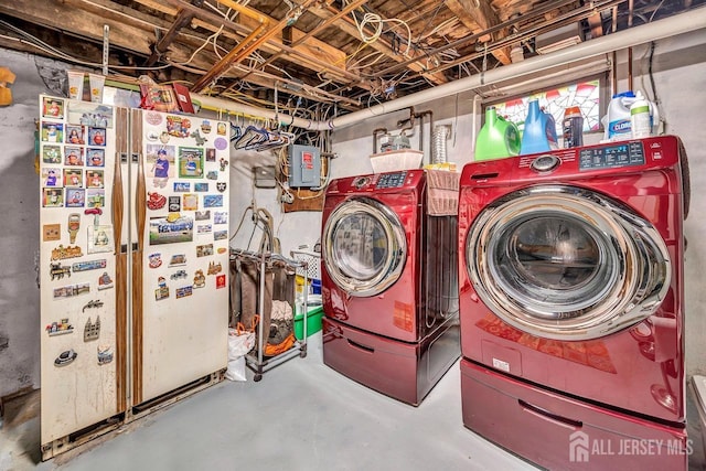 clothes washing area with washer and dryer and electric panel