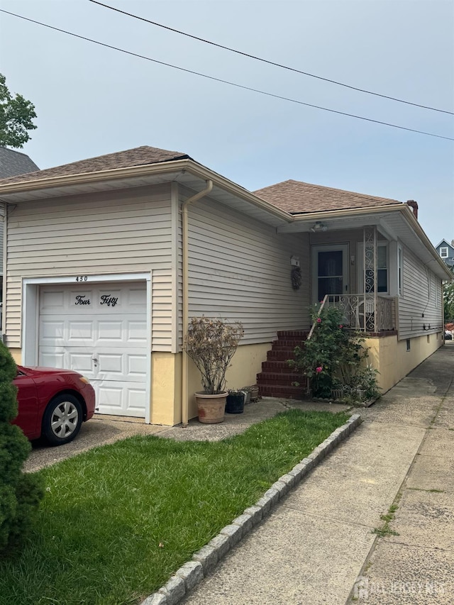 450 Brace Ave, Perth Amboy, NJ 08861 - view of front of home with a garage, driveway, and roof with shingles
