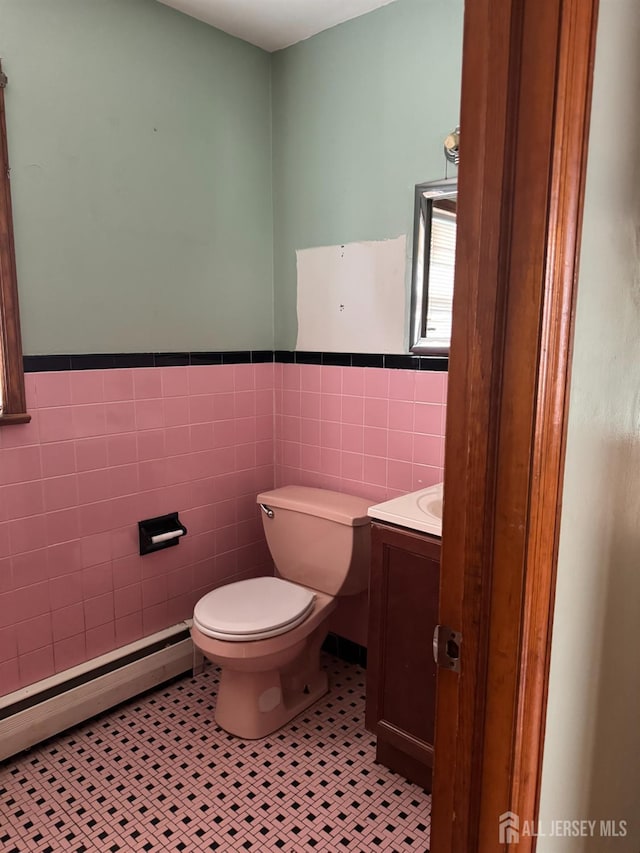 450 Brace Ave, Perth Amboy, NJ 08861 - half bath with tile walls, vanity, wainscoting, tile patterned floors, and a baseboard radiator