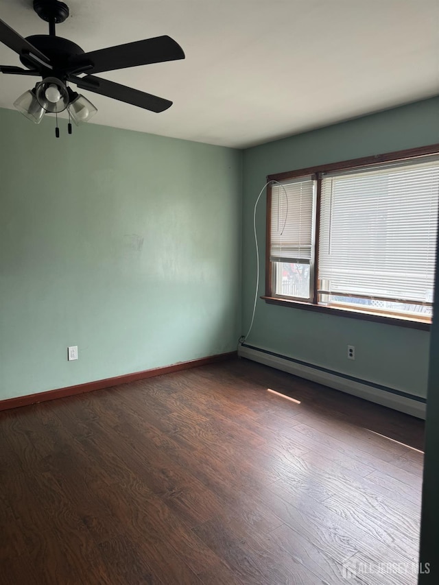 450 Brace Ave, Perth Amboy, NJ 08861 - empty room featuring a baseboard heating unit, ceiling fan, and dark wood-style flooring