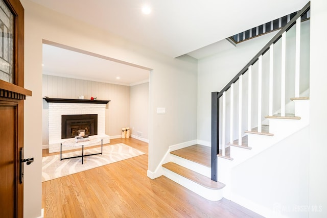 5 Wedgewood Ln, Holmdel, NJ 07733 - stairway with wood finished floors, crown molding, recessed lighting, and a fireplace