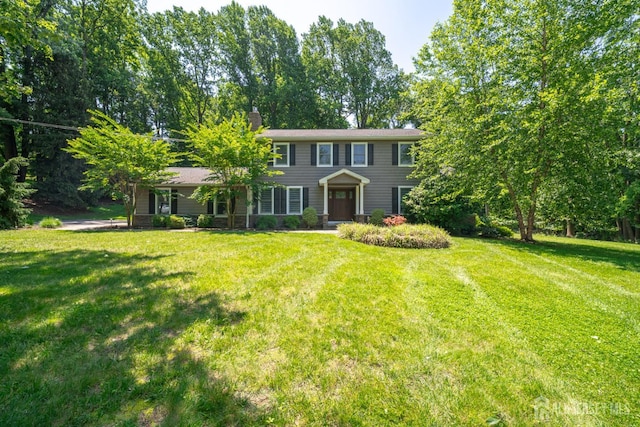 5 Wedgewood Ln, Holmdel, NJ 07733 - colonial-style house featuring a front lawn and a chimney