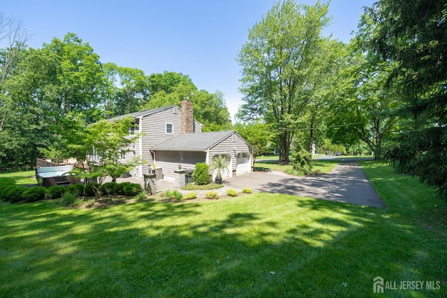 5 Wedgewood Ln, Holmdel, NJ 07733 - view of front of property featuring a chimney, a front yard, a garage, and asphalt driveway
