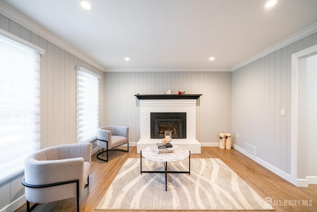 5 Wedgewood Ln, Holmdel, NJ 07733 - living area with crown molding, a brick fireplace, wood finished floors, and recessed lighting
