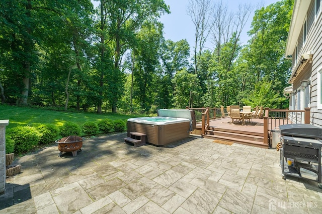 5 Wedgewood Ln, Holmdel, NJ 07733 - view of patio featuring a hot tub, an outdoor fire pit, outdoor dining space, a wooden deck, and area for grilling