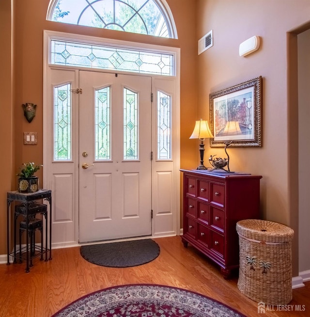 128 Fontaine Ct, Monroe, NJ 08831 - entryway featuring wood finished floors, baseboards, and a towering ceiling