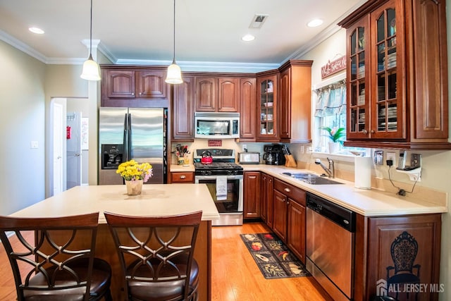 128 Fontaine Ct, Monroe, NJ 08831 - kitchen with appliances with stainless steel finishes, a sink, light countertops, light wood finished floors, and crown molding