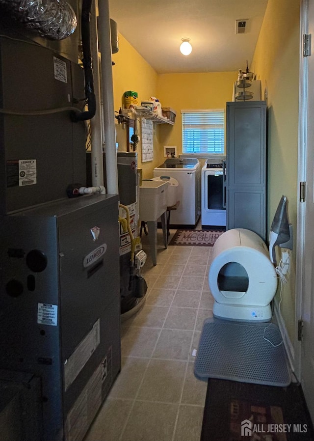 128 Fontaine Ct, Monroe, NJ 08831 - laundry area with washing machine and clothes dryer, heating unit, water heater, and tile patterned flooring