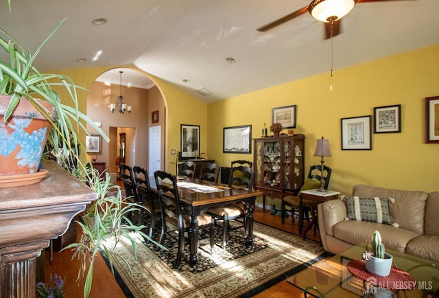 128 Fontaine Ct, Monroe, NJ 08831 - dining area featuring arched walkways, a ceiling fan, wood finished floors, high vaulted ceiling, and a chandelier