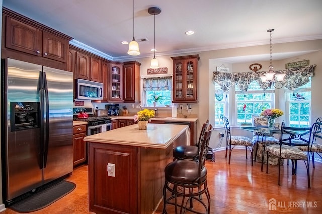 128 Fontaine Ct, Monroe, NJ 08831 - kitchen featuring stainless steel appliances, ornamental molding, light countertops, a chandelier, and a kitchen island