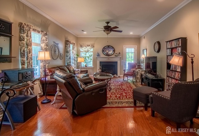 128 Fontaine Ct, Monroe, NJ 08831 - living area featuring ceiling fan, a fireplace, light wood-style floors, and ornamental molding