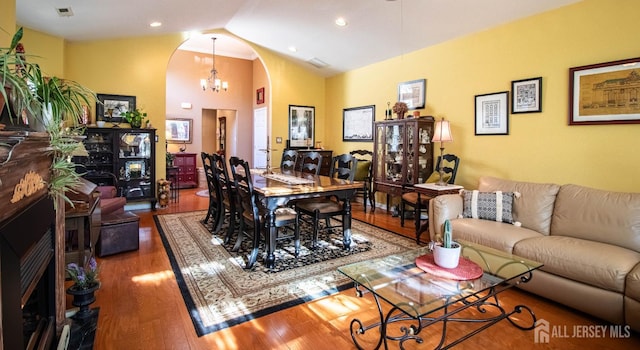 128 Fontaine Ct, Monroe, NJ 08831 - living area featuring arched walkways, wood finished floors, a chandelier, recessed lighting, and high vaulted ceiling
