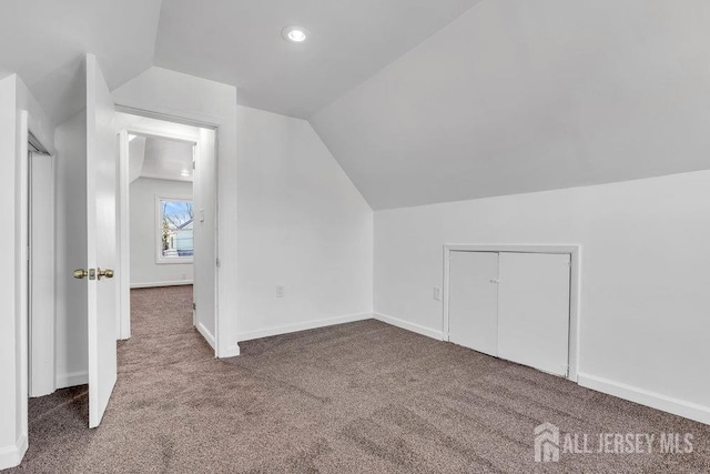 bonus room featuring carpet floors and vaulted ceiling