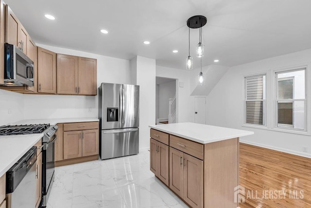 kitchen with appliances with stainless steel finishes, decorative light fixtures, and a kitchen island