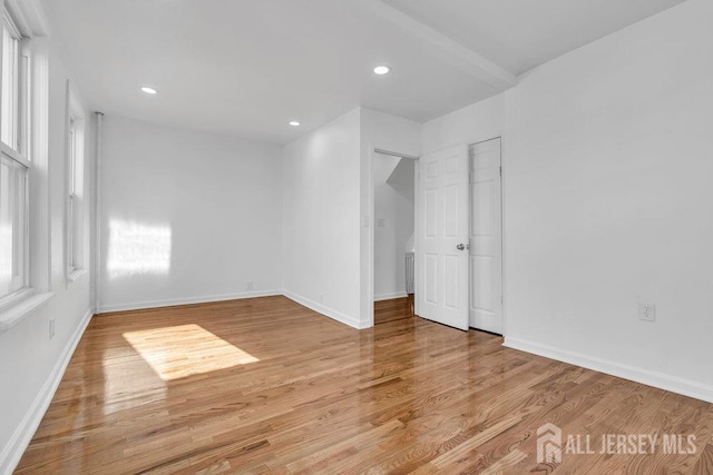 empty room featuring light hardwood / wood-style flooring and a wealth of natural light