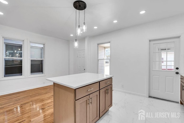 kitchen featuring decorative light fixtures and a kitchen island