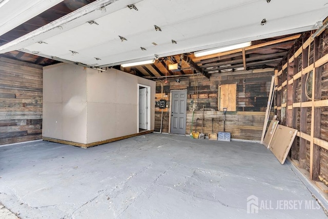 garage featuring wooden walls