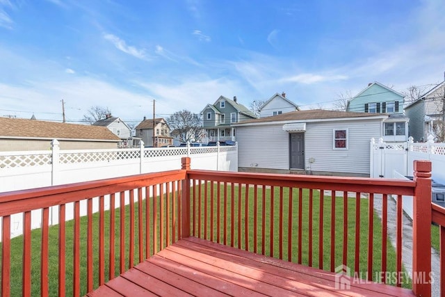 wooden deck featuring a lawn