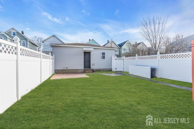 rear view of house with a lawn