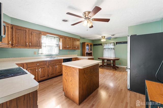 109 Russell St, Woodbridge Proper, NJ 07095 - kitchen with freestanding refrigerator, ceiling fan, light wood-style flooring, a center island, and light countertops