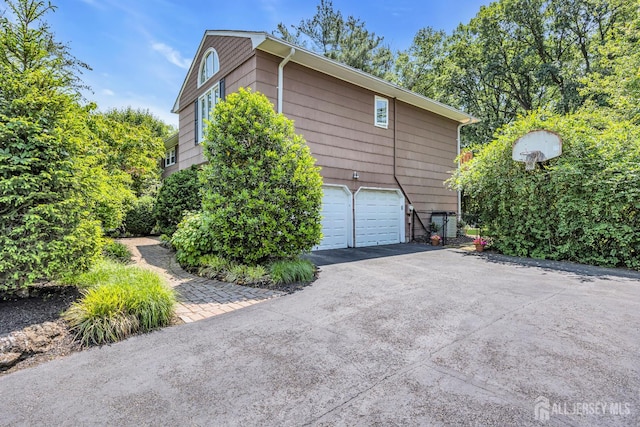10 Margie Rd, East Brunswick, NJ 08816 - view of side of home featuring asphalt driveway and a garage