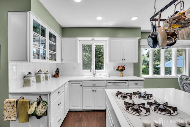 10 Margie Rd, East Brunswick, NJ 08816 - kitchen featuring a sink, white appliances, glass insert cabinets, light countertops, and white cabinetry