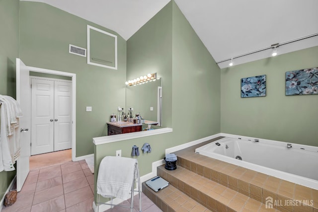 10 Margie Rd, East Brunswick, NJ 08816 - bathroom featuring a tub with jets, track lighting, vanity, tile patterned floors, and baseboards