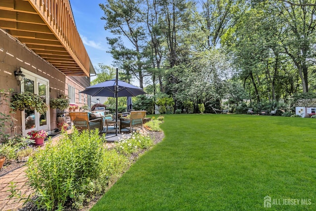 10 Margie Rd, East Brunswick, NJ 08816 - view of grassy yard featuring a patio and an outdoor living space