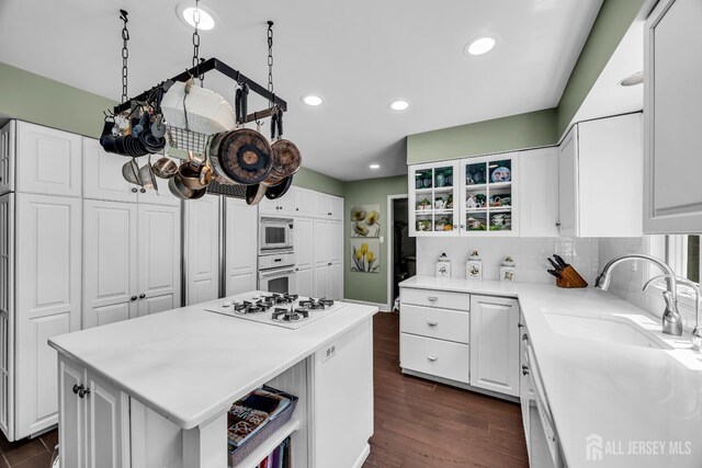 10 Margie Rd, East Brunswick, NJ 08816 - kitchen featuring a sink, white appliances, white cabinets, light countertops, and recessed lighting