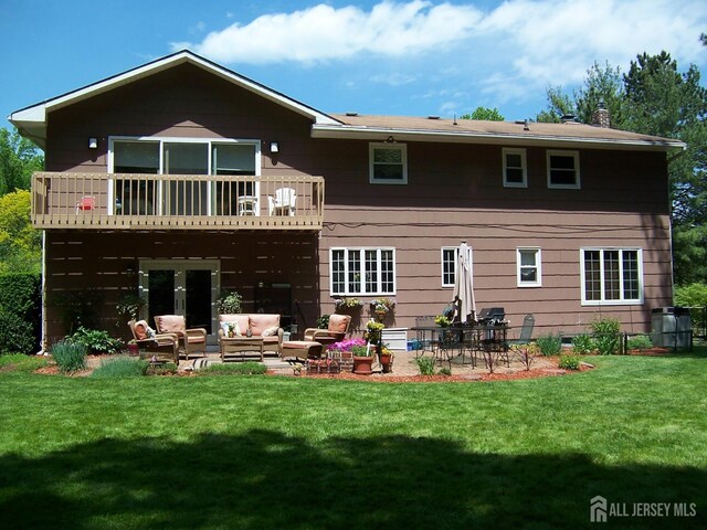 10 Margie Rd, East Brunswick, NJ 08816 - back of house featuring an outdoor hangout area, a lawn, a patio area, and a chimney