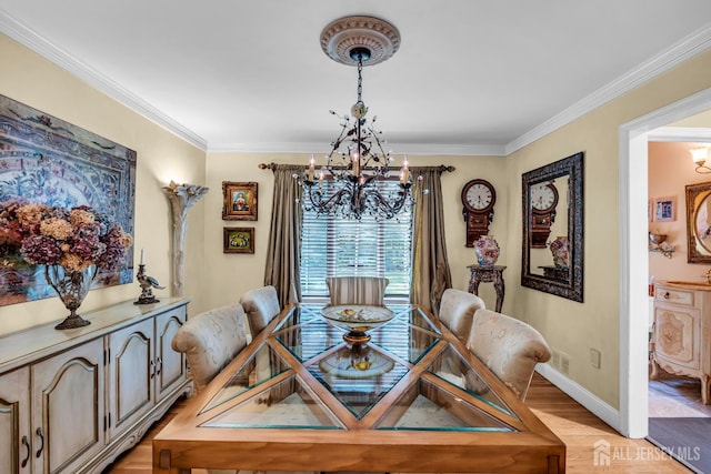 10 Margie Rd, East Brunswick, NJ 08816 - dining area featuring a chandelier, light wood-style floors, baseboards, and crown molding