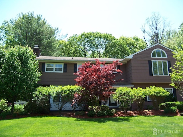 10 Margie Rd, East Brunswick, NJ 08816 - view of front of property with a front yard and a chimney