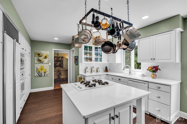 10 Margie Rd, East Brunswick, NJ 08816 - kitchen with white appliances, dark wood finished floors, tasteful backsplash, baseboards, and light countertops