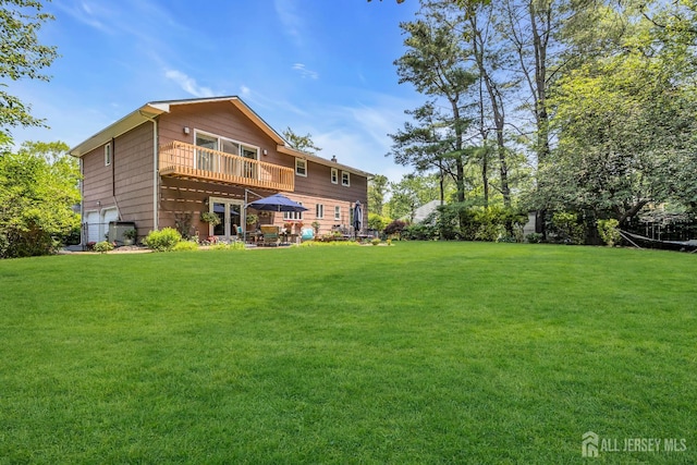 10 Margie Rd, East Brunswick, NJ 08816 - back of house featuring a yard, a garage, and a patio