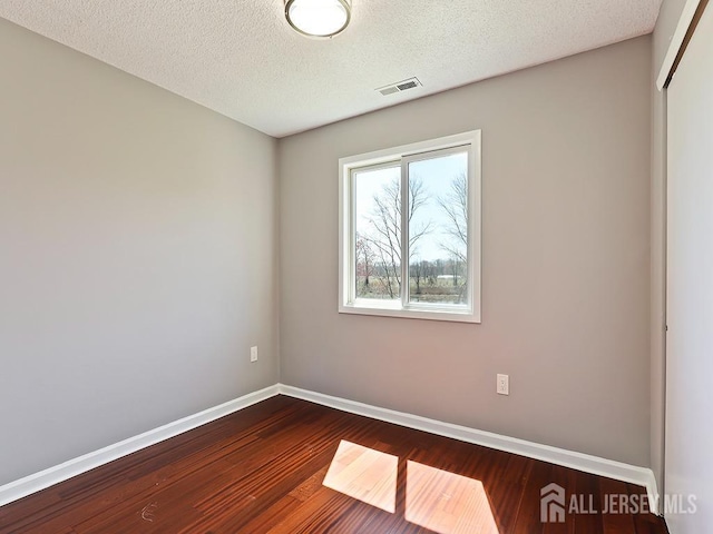 1010 Aspen Dr, Plainsboro, NJ 08536 - spare room with dark wood-type flooring, baseboards, and a textured ceiling