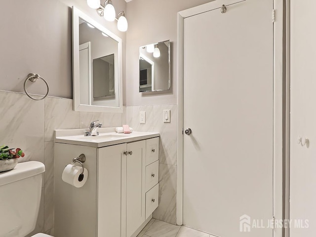 1010 Aspen Dr, Plainsboro, NJ 08536 - half bathroom with tile walls, vanity, toilet, and wainscoting