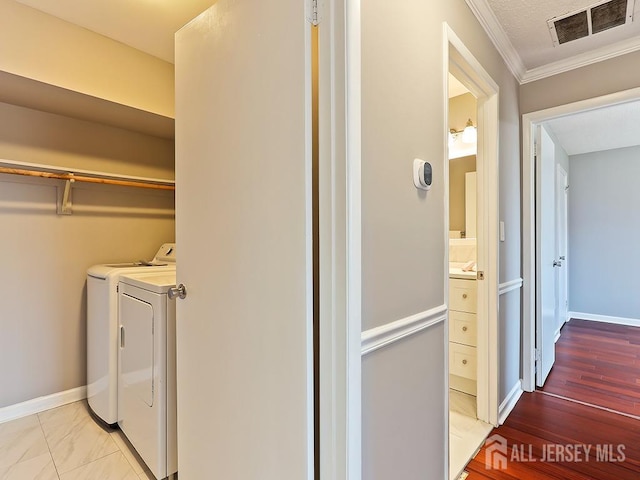 1010 Aspen Dr, Plainsboro, NJ 08536 - laundry area featuring separate washer and dryer, crown molding, and baseboards