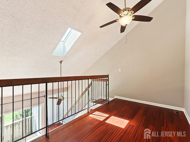 1010 Aspen Dr, Plainsboro, NJ 08536 - corridor with a textured ceiling, a skylight, baseboards, wood finished floors, and an upstairs landing