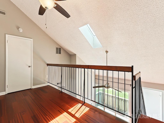 1010 Aspen Dr, Plainsboro, NJ 08536 - hallway featuring a textured ceiling, a skylight, wood finished floors, and high vaulted ceiling