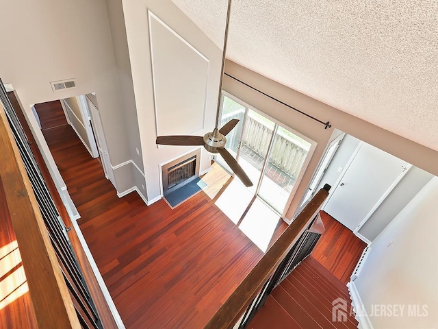 1010 Aspen Dr, Plainsboro, NJ 08536 - stairway featuring wood finished floors, a textured ceiling, baseboards, and ceiling fan
