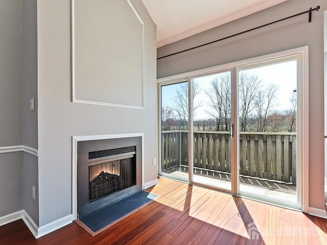 1010 Aspen Dr, Plainsboro, NJ 08536 - unfurnished living room featuring wood finished floors, baseboards, and a lit fireplace
