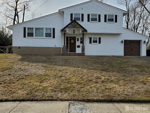 tri-level home featuring a front lawn and an attached garage