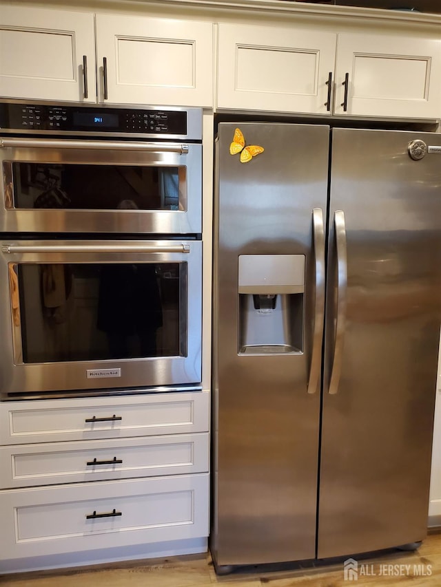 kitchen featuring appliances with stainless steel finishes and white cabinets