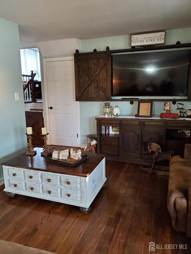 interior space featuring dark wood-style floors and a barn door