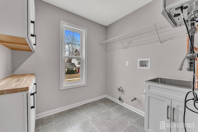 28 Kenmore Rd, Edison, NJ 08817 - washroom with gas dryer hookup, baseboards, washer hookup, and cabinet space