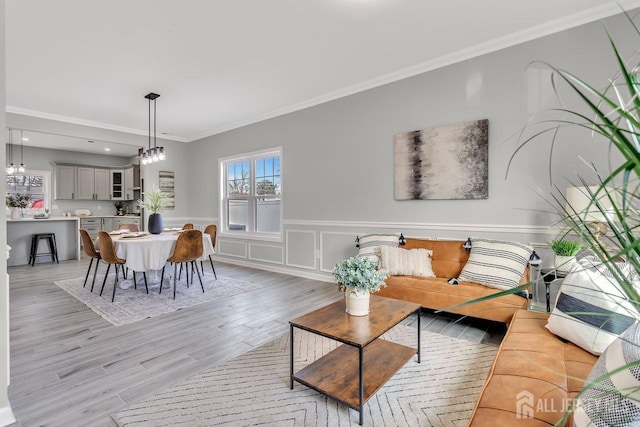 28 Kenmore Rd, Edison, NJ 08817 - living room featuring crown molding, light wood-type flooring, wainscoting, and a chandelier