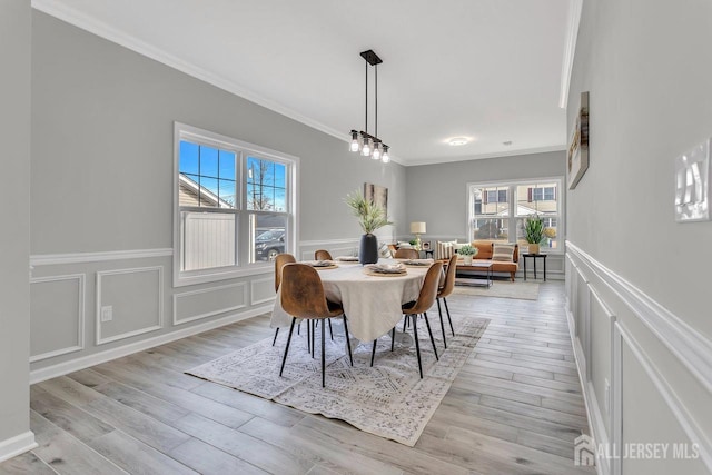 28 Kenmore Rd, Edison, NJ 08817 - dining space featuring a decorative wall, crown molding, a wainscoted wall, and light wood-style flooring